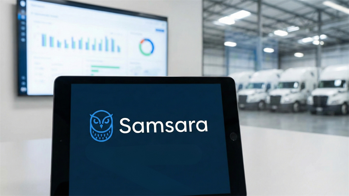 Samsara logo on tablet in warehouse fleet bay, with vans and analytics dashboard in background.