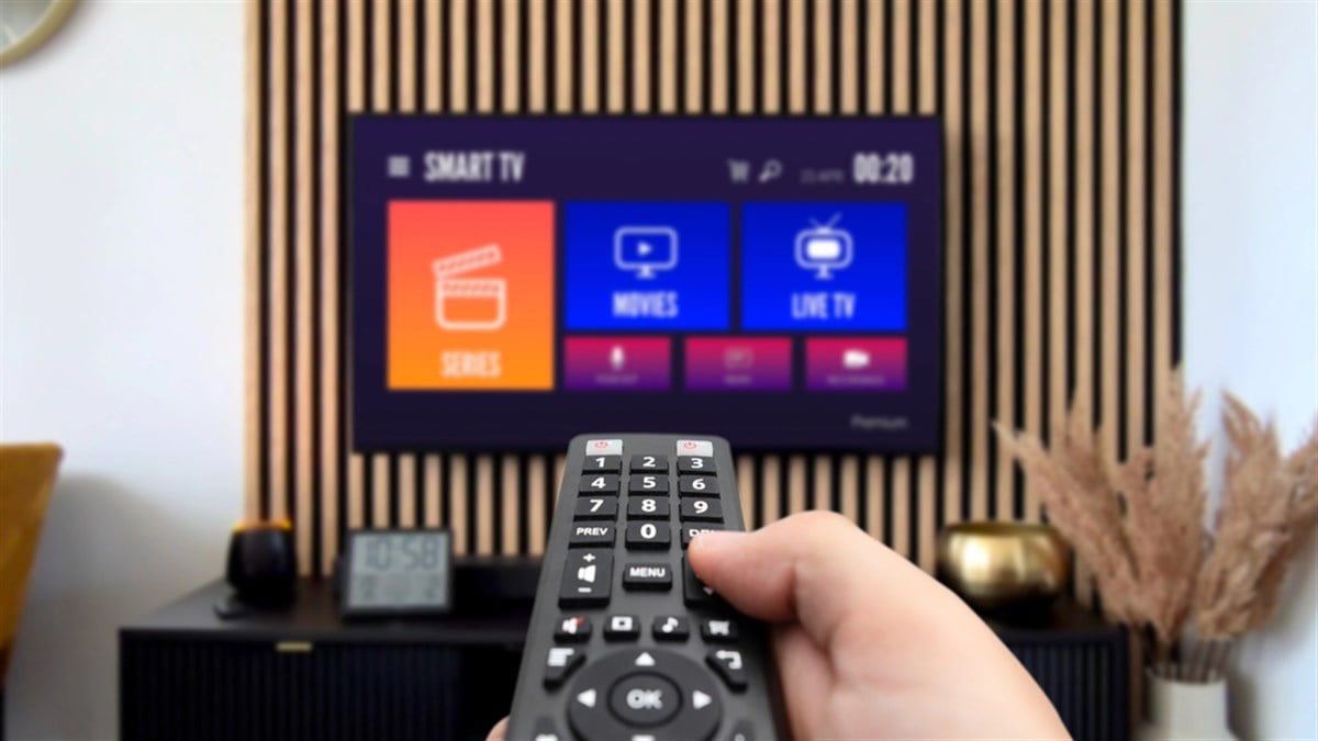 VOD multimedia TV streaming concept with hand holding remote control — Photo