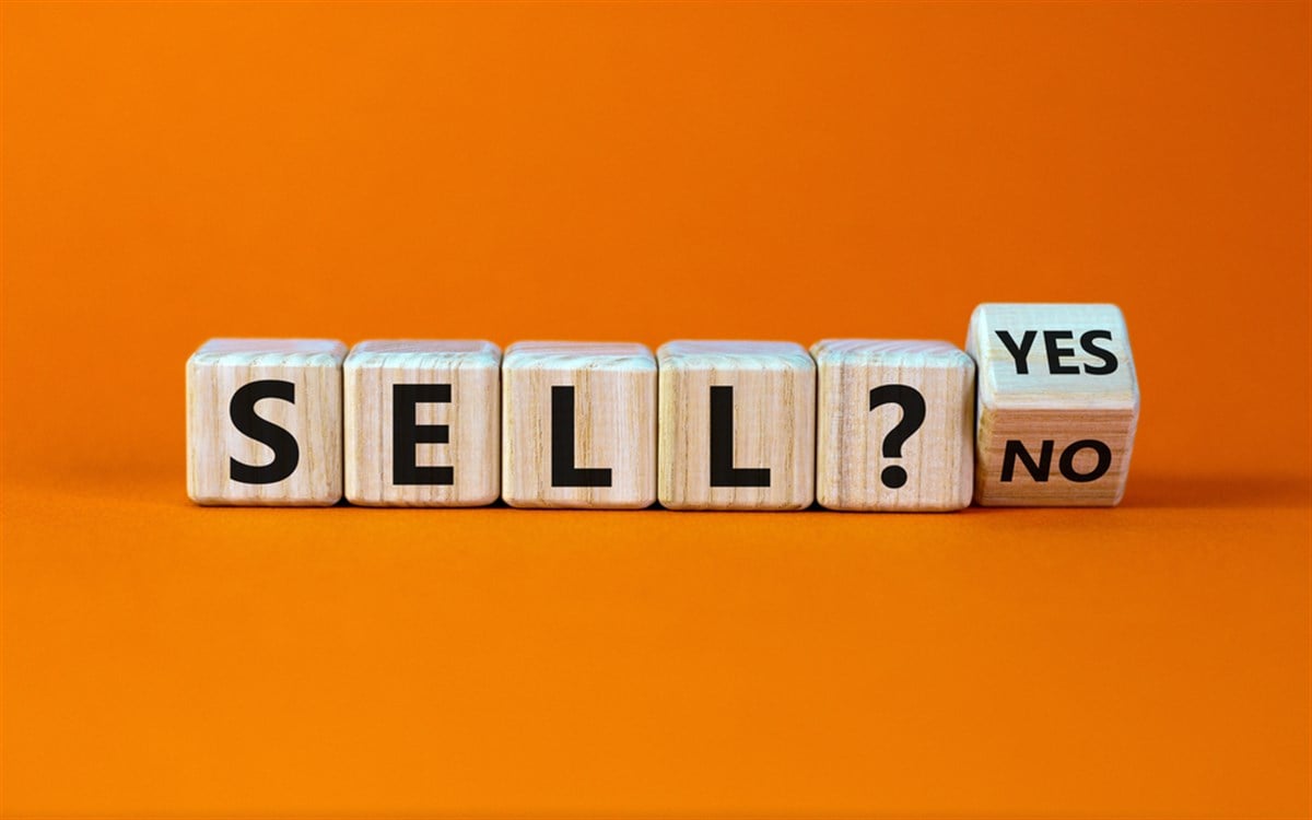 Wooden cubes spelling 'sell' with yes or no block.