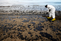 FILE - A worker removes oil from sand at Refugio State Beach, north of Goleta, Calif., on May 21, 2015. (AP Photo/Jae C. Hong, File, File)