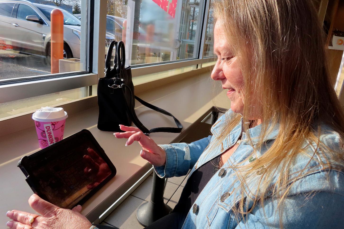 Elaine Vallaster plays an internet slots game on her tablet in Hazlet, N.J. on Friday, Nov. 24, 2023. Internet gambling is currently offered in six states but has been slow to catch on more widely in the U.S. (AP Photo/Wayne Parry)