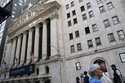 Pedestrians pass the New York Stock Exchange, May 5, 2022, in the Manhattan borough of New York. Stocks are opening broadly lower on Wall Street Thursday, June 30, 2022 continuing a dismal streak that brought on a bear market earlier this month and has the S&P 500 on track for its worst quarter since the early days of the pandemic at the beginning of 2020. (AP Photo/John Minchillo, file)