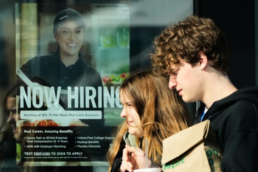 A hiring sign is displayed at a restaurant, in Niles, Ill., Tuesday, April 7, 2026. (AP Photo/Nam Y. Huh)