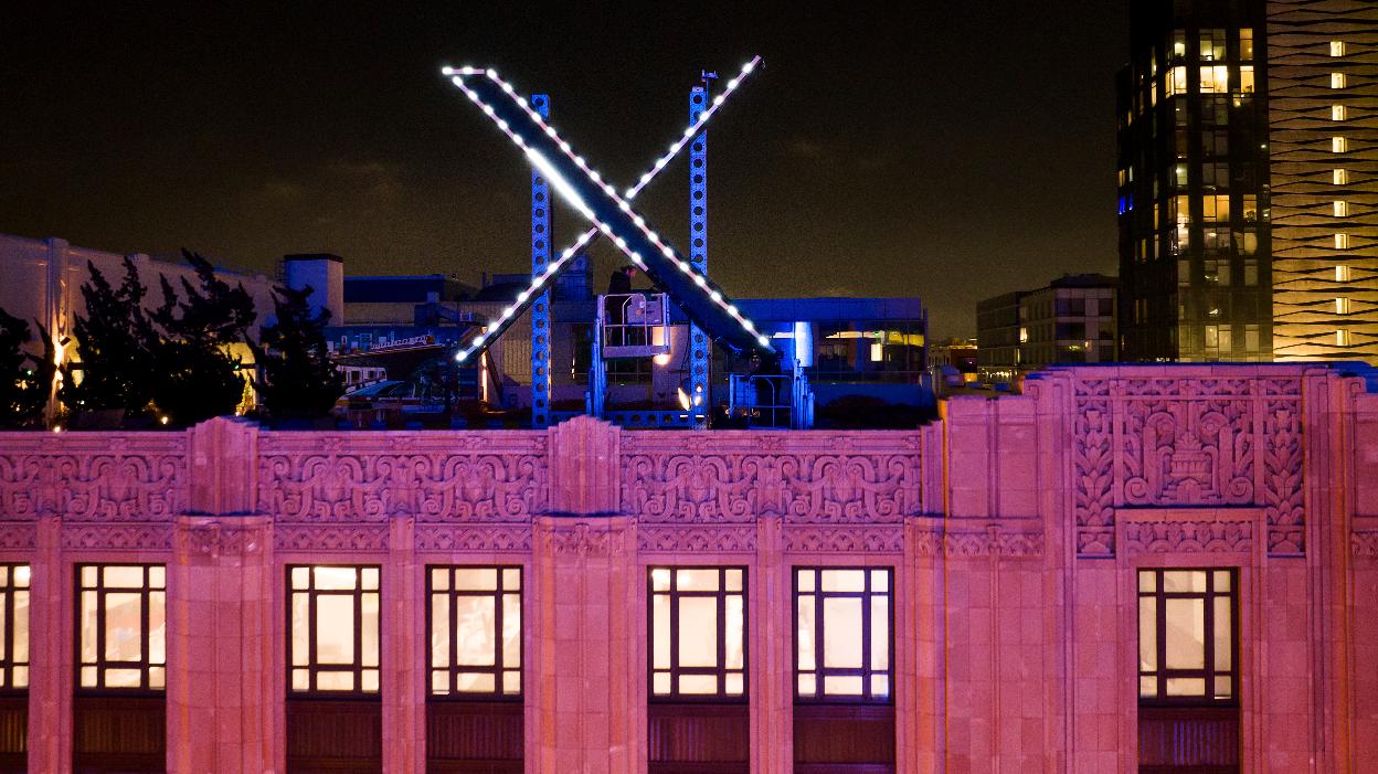 FILE - Workers install lighting on an "X" sign atop the company headquarters, formerly known as Twitter, in downtown San Francisco, on Friday, July 28, 2023. (AP Photo/Noah Berger, File)