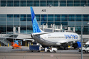 FILE - A United Airlines jetliner sits at a gate along the A concourse of Denver International Airport, March 20, 2026, in Denver. (AP Photo/David Zalubowski, File)