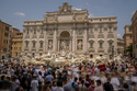FILE - Tourists visit the Trevi Fountain in Rome, Friday, June 30, 2023. (AP Photo/Andrew Medichini, File)