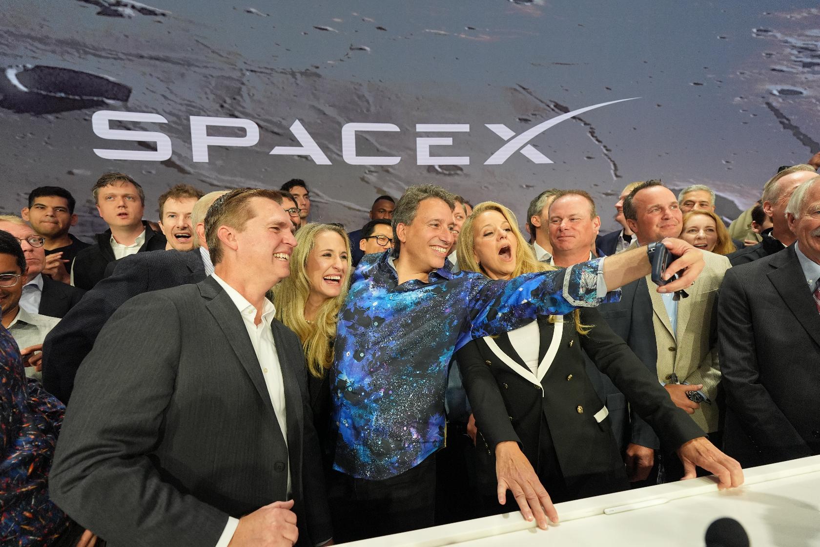 Gwynne Shotwell, President and COO of SpaceX, right, poses with colleagues during a bell ringing ceremony for the IPO of SpaceX at the Nasdaq MarketSite in New York, Friday, June 12, 2026, in New York. (AP Photo/Frank Franklin II)