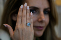 FILE - Sotheby's Deputy Chairman, Middle East & Head of Sotheby's UAE, Katia Noun Boueiz wears the Mediterranean Blue diamond during its worldwide debut in Abu Dhabi, United Arab Emirates, Tuesday, April 8, 2025. (AP Photo/Altaf Qadri, file)