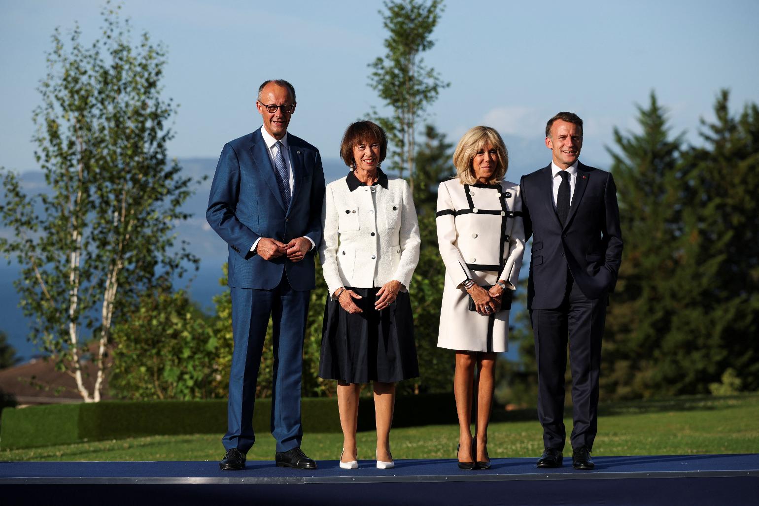 French President Emmanuel Macron, right, and his wife Brigitte Macron, second right, pose with Germany's Chancellor Friedrich Merz and his wife Charlotte Merz during the G7 summit in Evian-les-Bains, France, Monday, June 15, 2026. (Isabel Infantes/Pool Photo via AP)