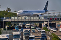 A Lufthansa aircraft rolls on a bridge over a highway at the airport in Frankfurt, Germany, Wednesday, April 22, 2026. (AP Photo/Michael Probst)