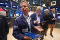 Trader Robert Charmak, left, works on the floor of the New York Stock Exchange, Thursday, May 7, 2026. (AP Photo/Richard Drew)