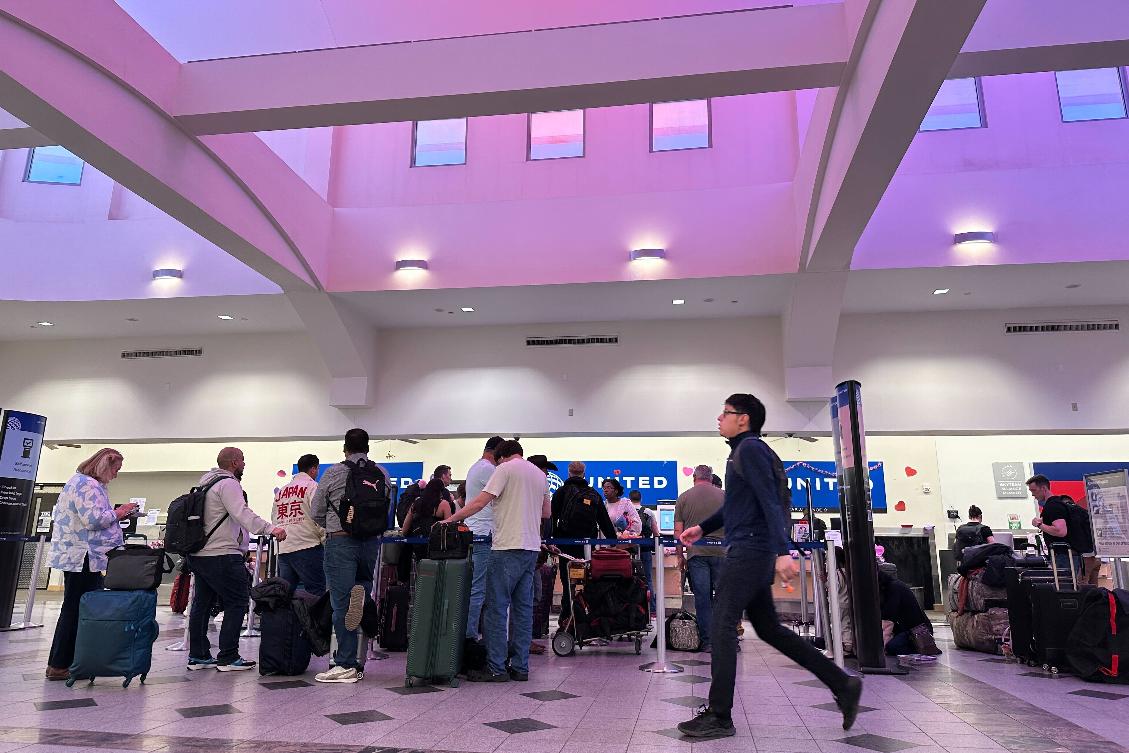 FILE - People stand in line at check-in counters at El Paso International Airport, Wednesday, Feb. 11, 2026, in El Paso, Texas. (AP Photo/Morgan Lee,File)