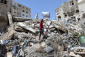 A man collects his family's belongings from the rubble of a building destroyed in an Israeli airstrike the previous day in the southern village of Maarakeh, Lebanon, Sunday, May 17, 2026. (AP Photo/Mustafa Jamalddine)