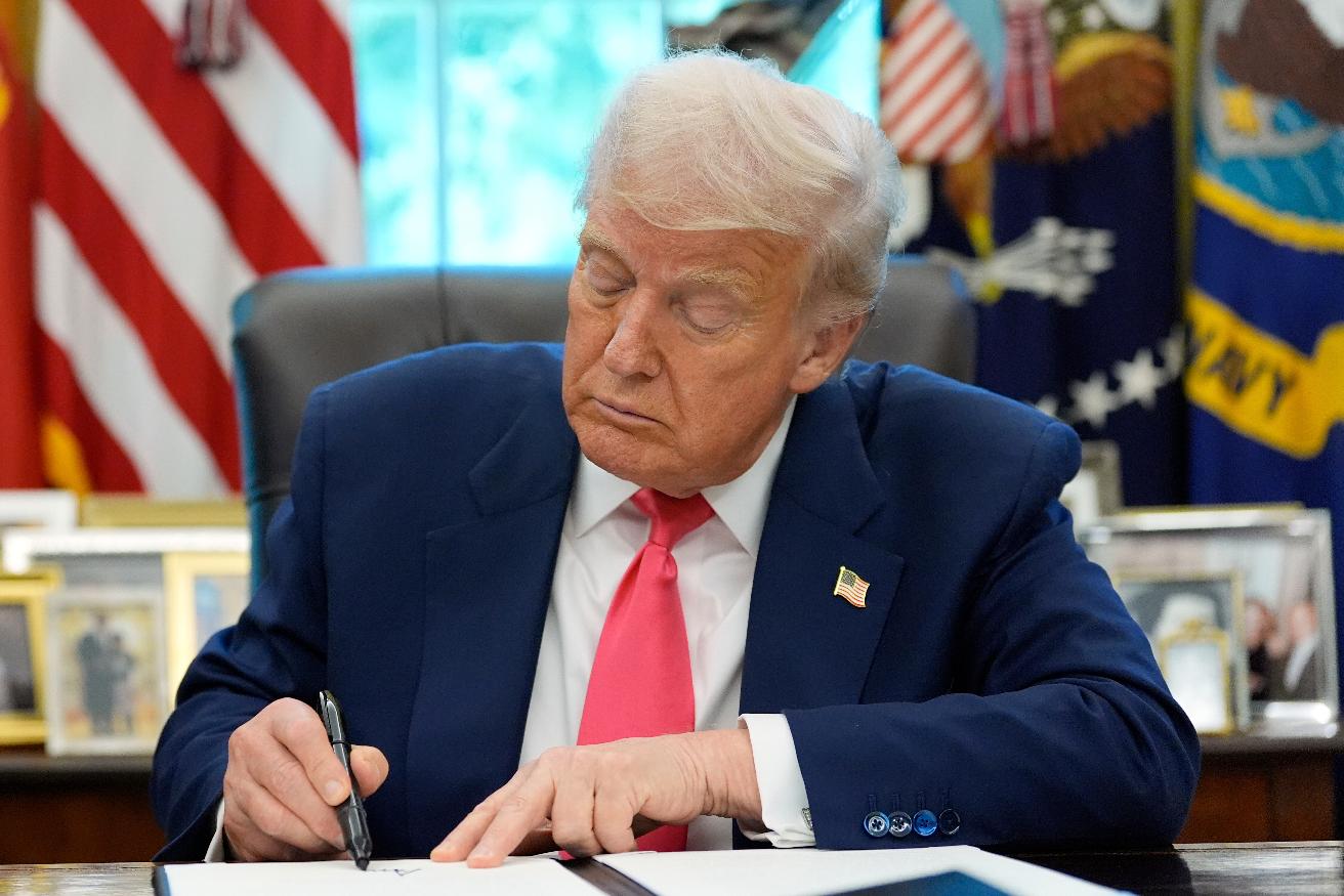 President Donald Trump signs a proclamation in the Oval Office honoring the 90th anniversary of the Social Security Act, Thursday, Aug. 14, 2025, in Washington. (AP Photo/Alex Brandon)