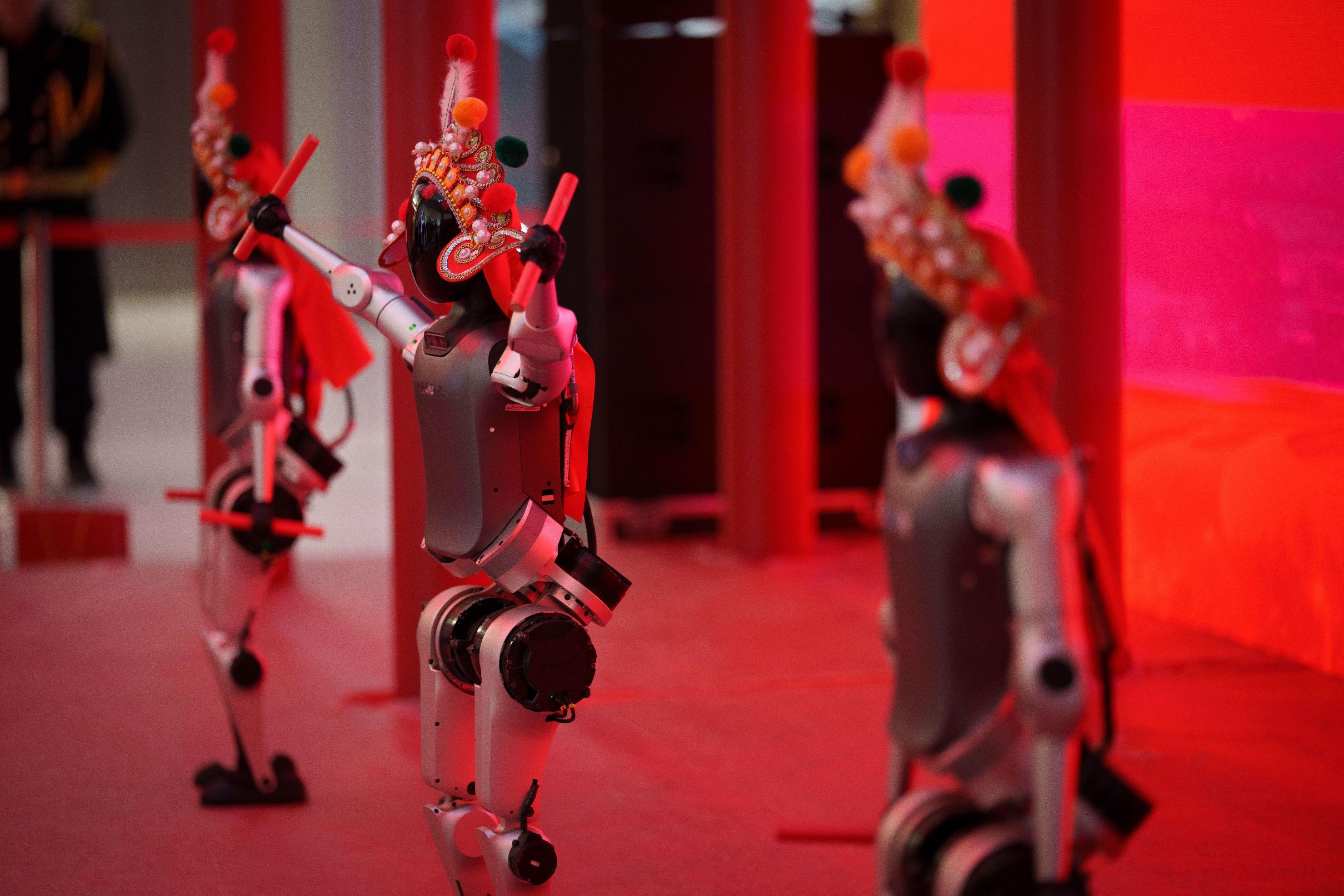 Humanoid robots perform during the media preview of a robotic temple fair celebrated ahead of Lunar New Year in Beijing, China, Friday, Feb. 13, 2026. (AP Photo/Vincent Thian)