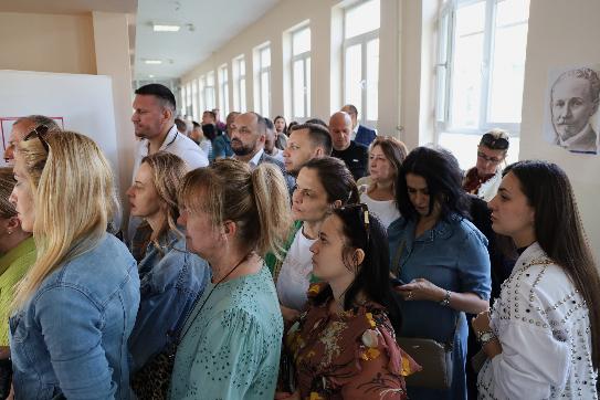 People wait in line at a polling station for an early parliamentary election, the third in 18 months, in the northern Serb-dominated part of ethnically divided town of Mitrovica, Kosovo, Sunday, June 7, 2026. (AP Photo/Dejan Simicevic)