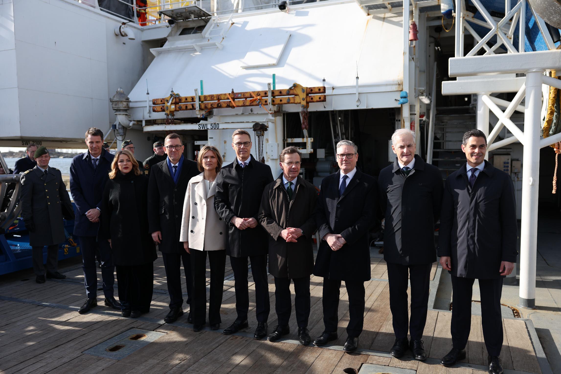 From left, Danish Permanent Under-Secretary of State for Foreign Affairs Anders Tang Friborg, Latvian Prime Minister Evika Silina, Estonian Prime Minister Kristen Michal, Icelandic Prime Minister Kristrun Frostadottir, Finnish President Alexander Stubb, Swedish Prime Minister Ulf Kristersson, British Prime Minister Keir Starmer, Norwegian Prime Minister Jonas Gahr Store and Dutch Prime Minister Rob Jetten pose for a group photo onboard the Finnish Border Guard offshore patrol vessel Turva, prior the Joint Expeditionary Force JEF Leaders' Summit meeting in Helsinki, Finland, Thursday March 26, 2026. (Adrian Dennis, Pool Photo via AP)