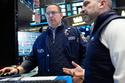 Anthony Matesic, left, and James Denaro work on the floor at the New York Stock Exchange in New York, Thursday, March 19, 2026. (AP Photo/Seth Wenig)
