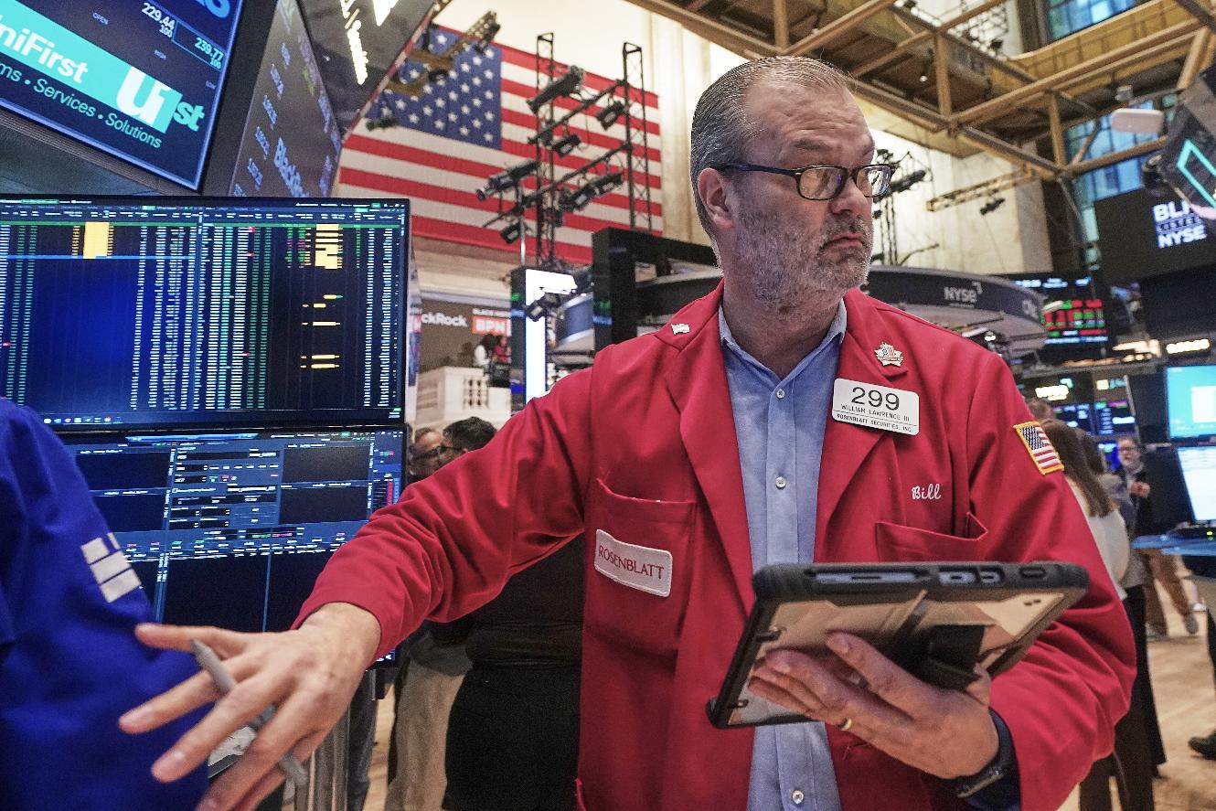 Trader William Lawrence works on the floor of the New York Stock Exchange, Friday, Feb. 13, 2026, in New York. (AP Photo/Richard Drew)
