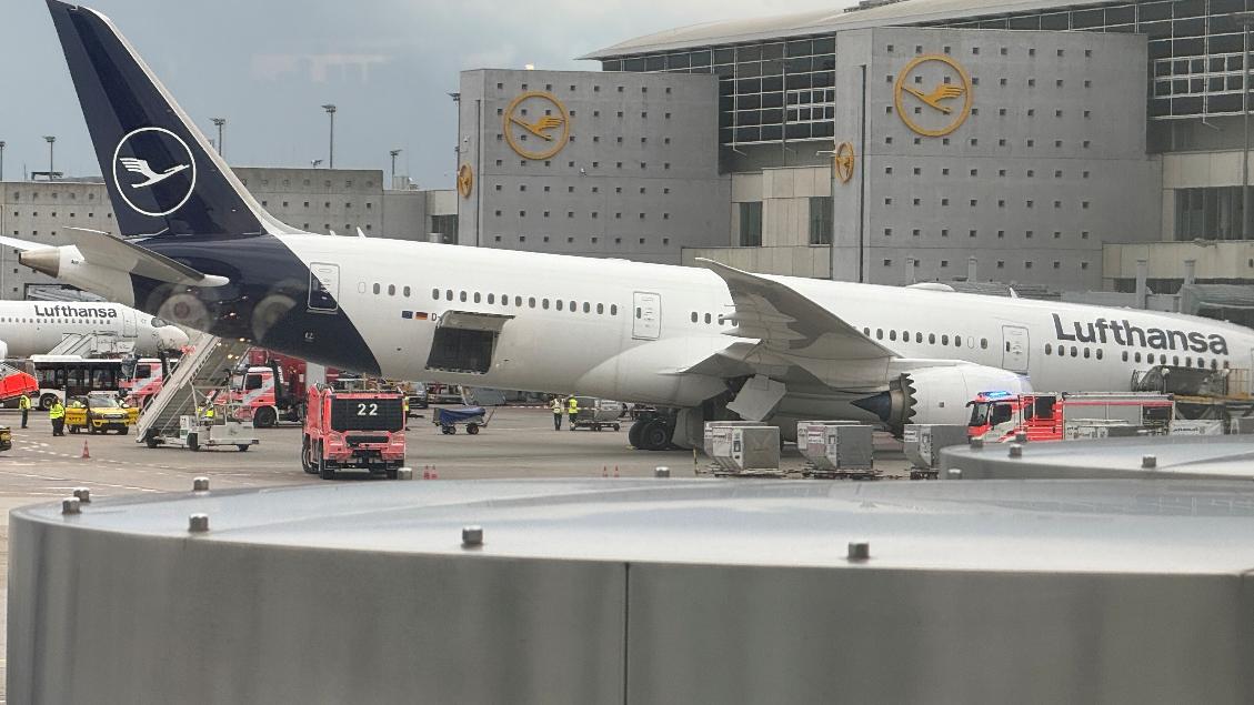 A Lufthansa 'Dreamliner' aircraft lies on its nose in front of a terminal at the Frankfurt Airport in Frankfurt, Germany, Thursday, June 4, 2026, after the nose landing gear collapsed. (Mike Seeboth/dpa via AP)