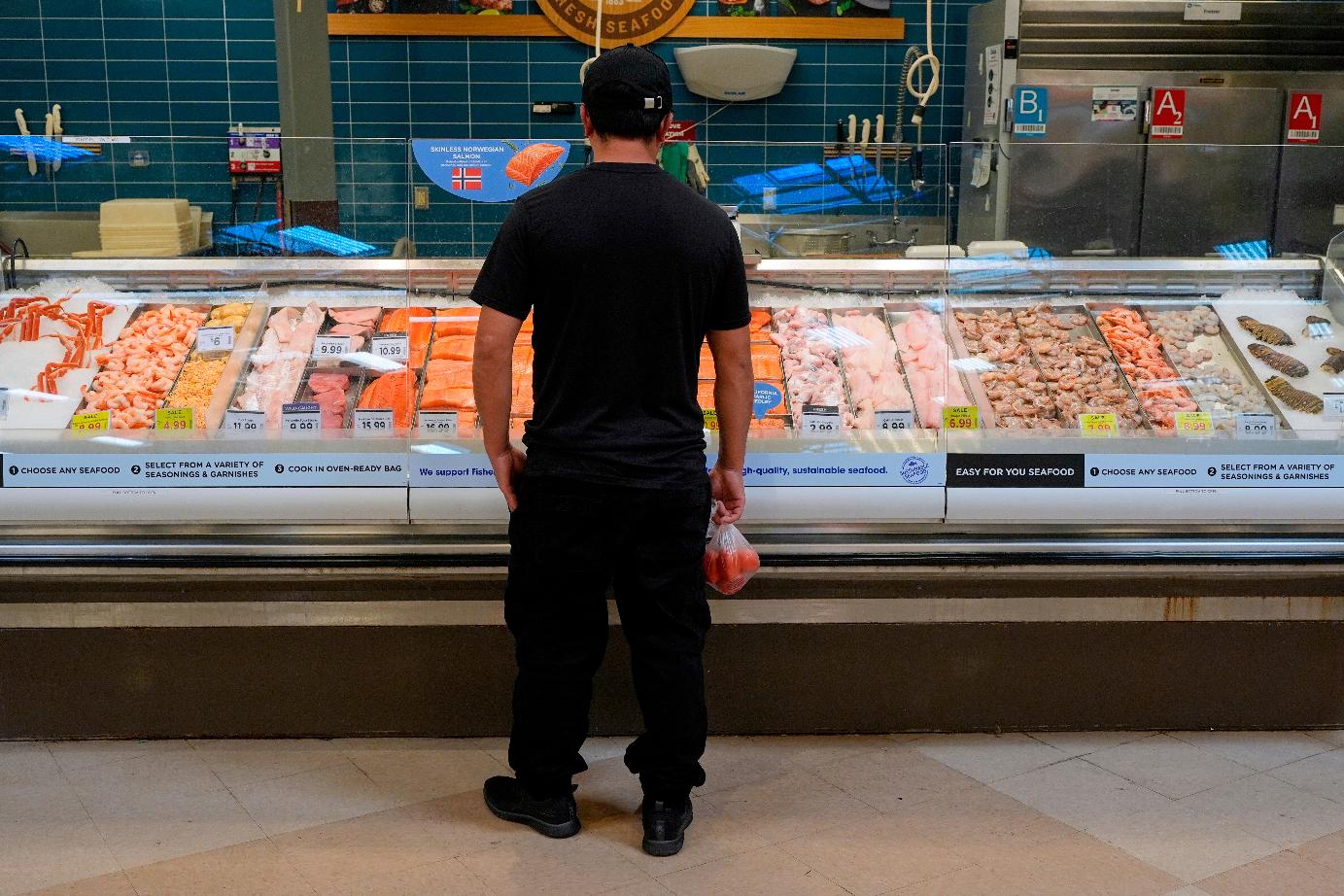 FILE - A person looks at the fresh fish at a grocery store Monday, May 11, 2026, in Nashville, Tenn. (AP Photo/George Walker IV, File)
