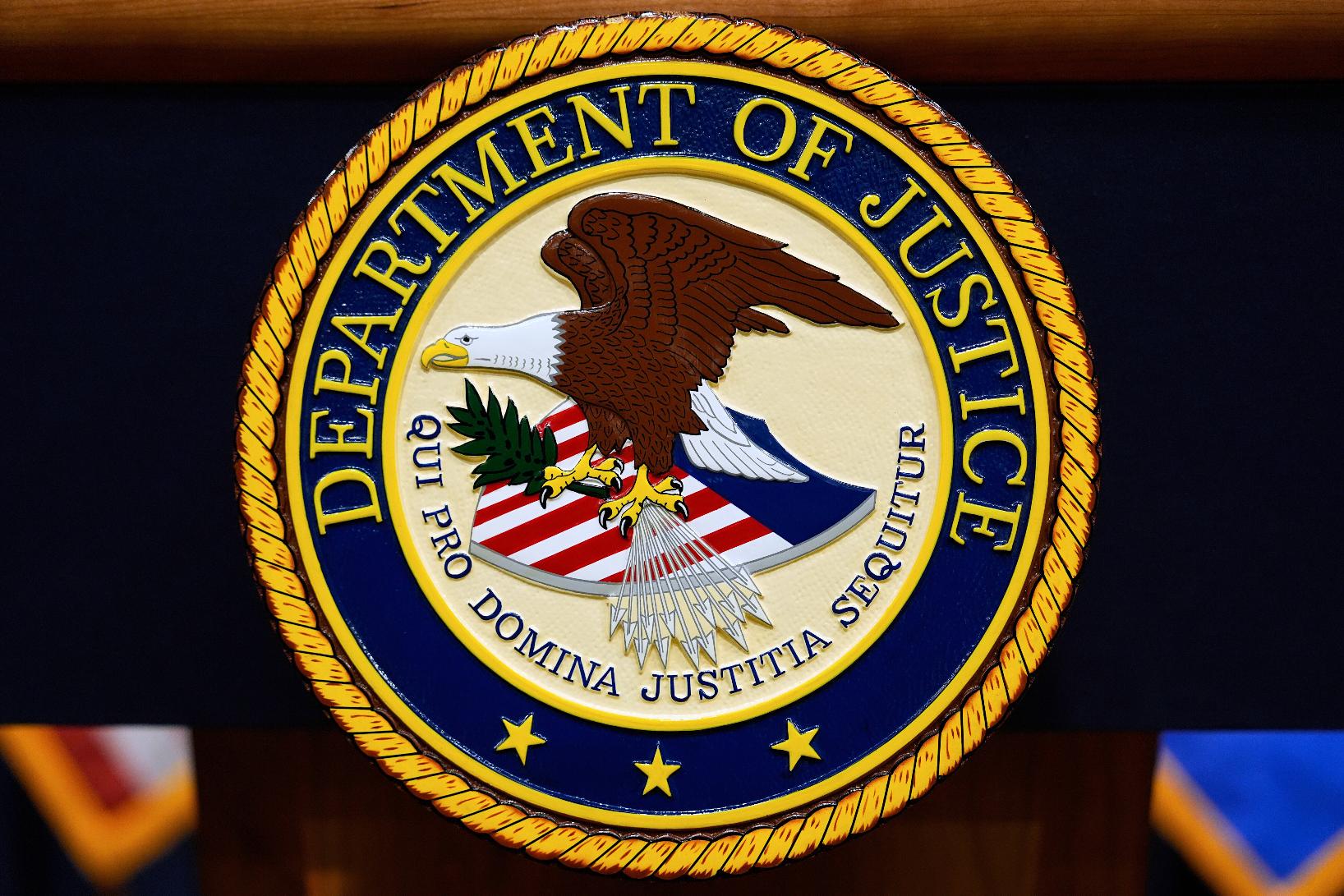 FILE - The U.S. Department of Justice logo is seen on a podium before a press conference, May 6, 2025, at the Justice Department in Washington. (AP Photo/Julia Demaree Nikhinson, File)
