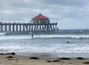 Surfers and swimmers return to the Huntington Beach pier waves since the crude oil spill at the California beach, Monday, Oct. 11, 2021. The reopening of Huntington Beach, dubbed "Surf City USA," came far sooner than many expected after a putrid smell blanketed the coast and blobs of crude began washing ashore. (AP Photo/Amy Taxin)
