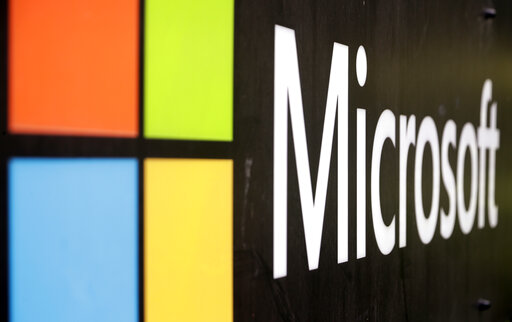 FILE - The Microsoft company logo is displayed at their offices in Sydney, Australia, on Wednesday, Feb. 3, 2021.  Microsoft has closed on its approximately $16 billion acquisition of speech recognition company Nuance. The deal, which was announced last year, helps Microsoft Corp. get more entrenched into hospitals and the health care industry through Nuance’s widely used medical dictation and transcription tools.  (AP Photo/Rick Rycroft, File)