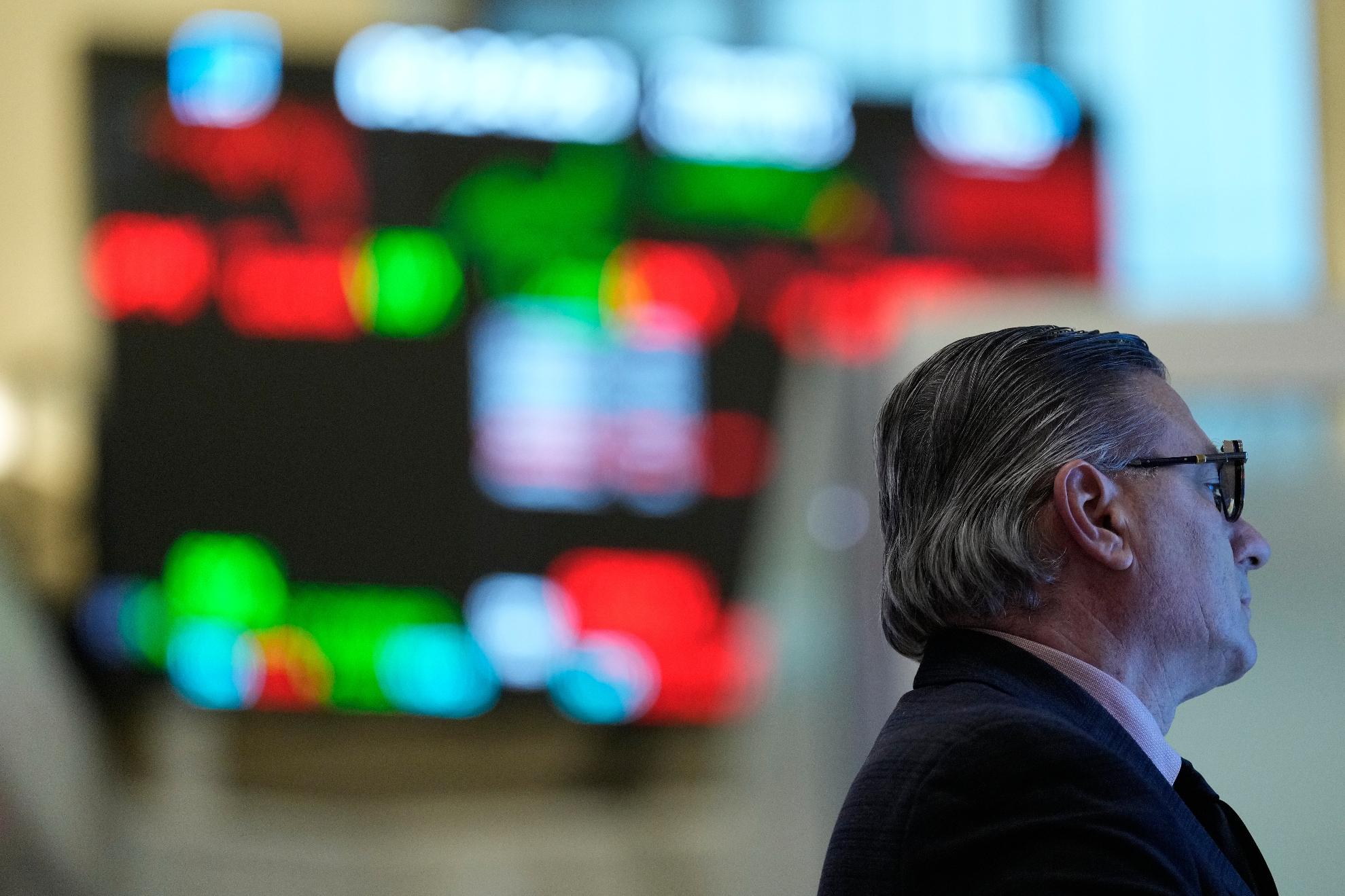 People work on the floor at the New York Stock Exchange in New York, Thursday, March 19, 2026. (AP Photo/Seth Wenig)