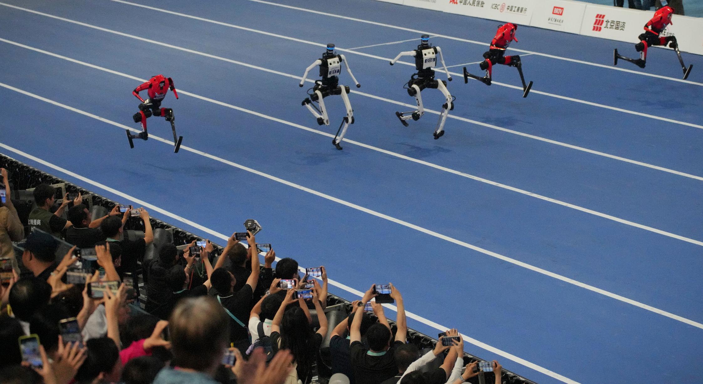 Humanoid robots compete in the 100 meter race during the World Humanoid Robot Games in Beijing, Wednesday, Aug. 26, 2026. (AP Photo/Achmad Ibrahim)