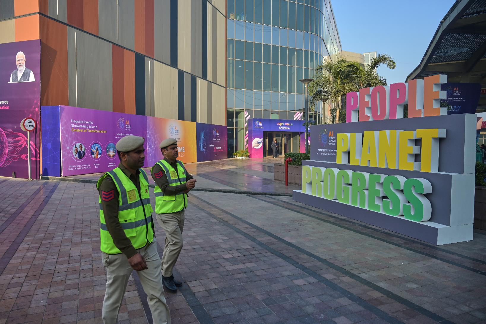 Security people walk at the venue of AI-Summit in New Delhi, India, Monday, Feb. 16, 2026. (AP Photo)