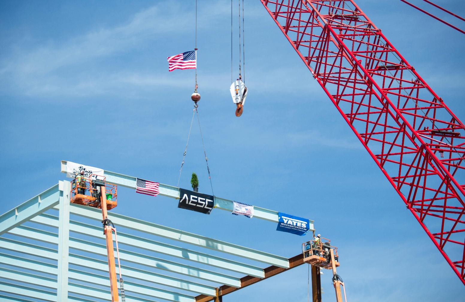 FILE - Construction crews prepare to mount the final structural steel beam on the 1.6 million-square-foot AESC gigafactory being constructed in the Kentucky Transpark in Bowling Green, Ky., during the facility's "Topping Out" structural completion milestone ceremony on Thursday, Sept. 14, 2023. (Grace Ramey /Daily News via AP)