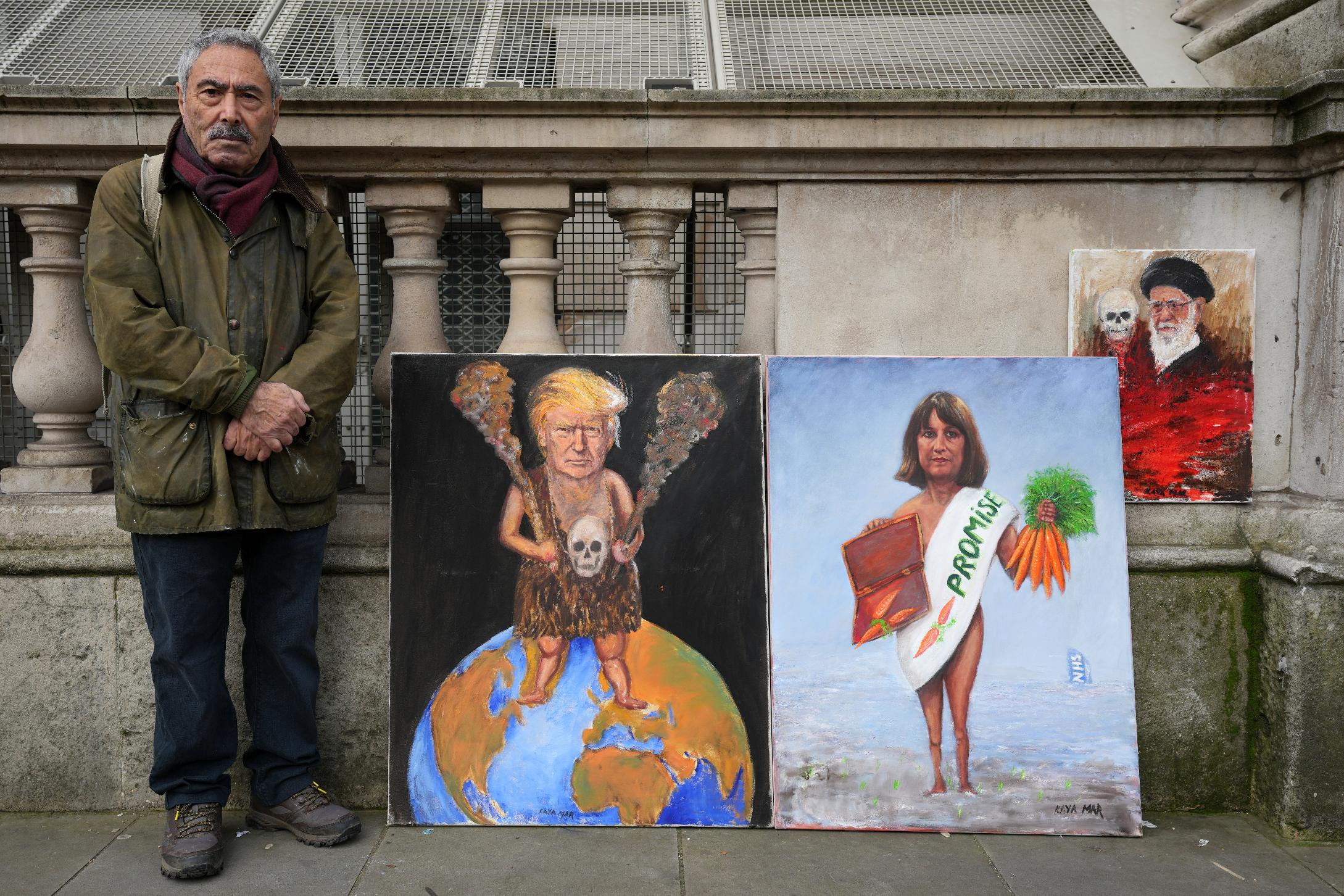 Artist Kaya Mar poses with his newest painting edition for photographers outside Downing Street before Britain's Chancellor of the Exchequer Rachel Reeves leaves to deliver the Spring Statement in London, Tuesday, March 3, 2026.(AP Photo/Kin Cheung)