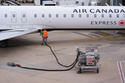 FILE - A worker fuels an Air Canada jet at DFW International Airport in Grapevine, Texas, Tuesday, April 14, 2026. (AP Photo/LM Otero, File)