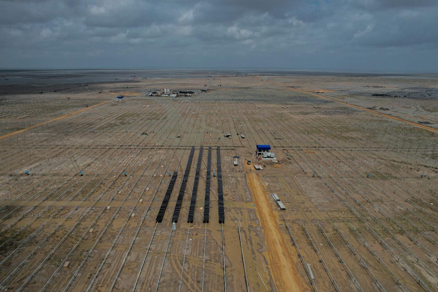 FILE - Solar panels are installed at an under-construction site of Adani Green Energy Limited's Renewable Energy Park in the salt desert of Karim Shahi village, near Khavda, Bhuj district near the border with Pakistan in the western Indian state of Gujarat, on Sept. 21, 2023. (AP Photo/Rafiq Maqbool, File)