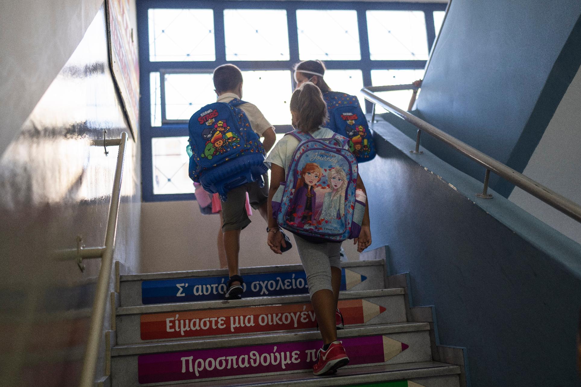 FILE - Students walk up stairs to enter their class during their first day of school at a public elementary school in Drapetsona suburb of Piraeus, near Athens, on Monday, Sept. 12, 2022.(AP Photo/Petros Giannakouris, File)