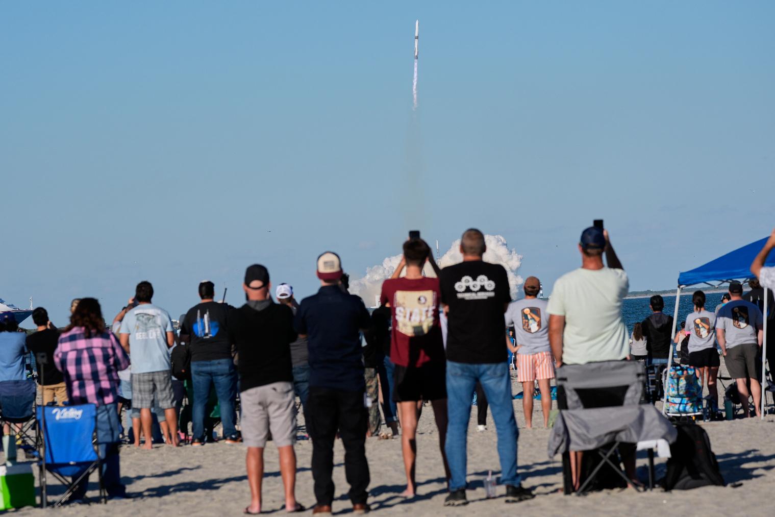 Spectators on the beach watch a Blue Origin New Glenn rocket as it lifts off from Launch Complex 36 at the Cape Canaveral Space Force Station in Cape Canaveral, Fla., Thursday, Nov. 13, 2025. (AP Photo/John Raoux)