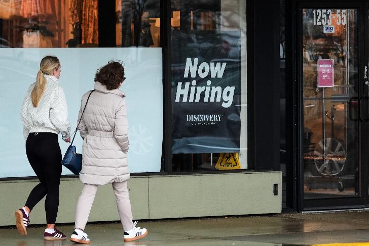 Now hiring sign is displayed at a retail store, in Arlington Heights, Ill., Thursday, April 2, 2026. (AP Photo/Nam Y. Huh)