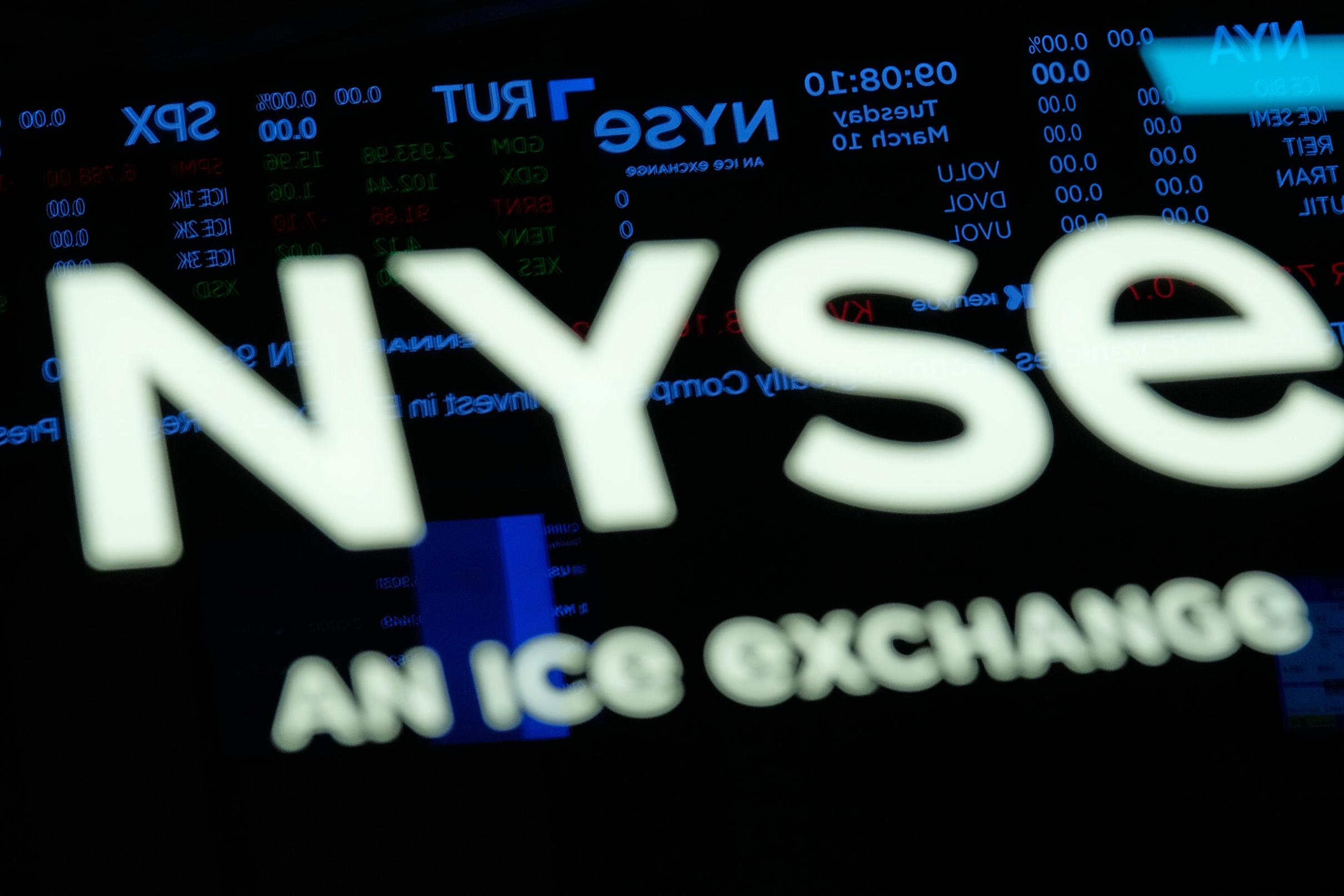 Screens display financial information on the floor at the New York Stock Exchange in New York, Tuesday, March 10, 2026. (AP Photo/Seth Wenig)