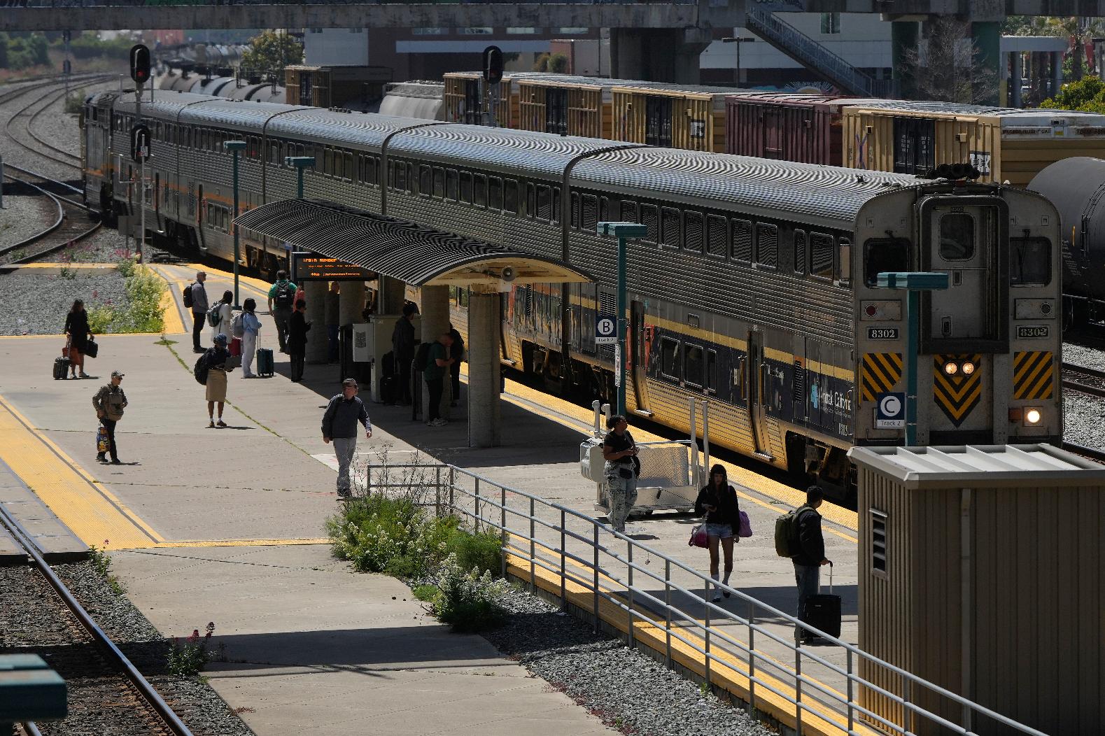 Passengers wait to board an Amtrak train at a station in Emeryville, Calif., Thursday, April 30, 2026. (AP Photo/Jeff Chiu)