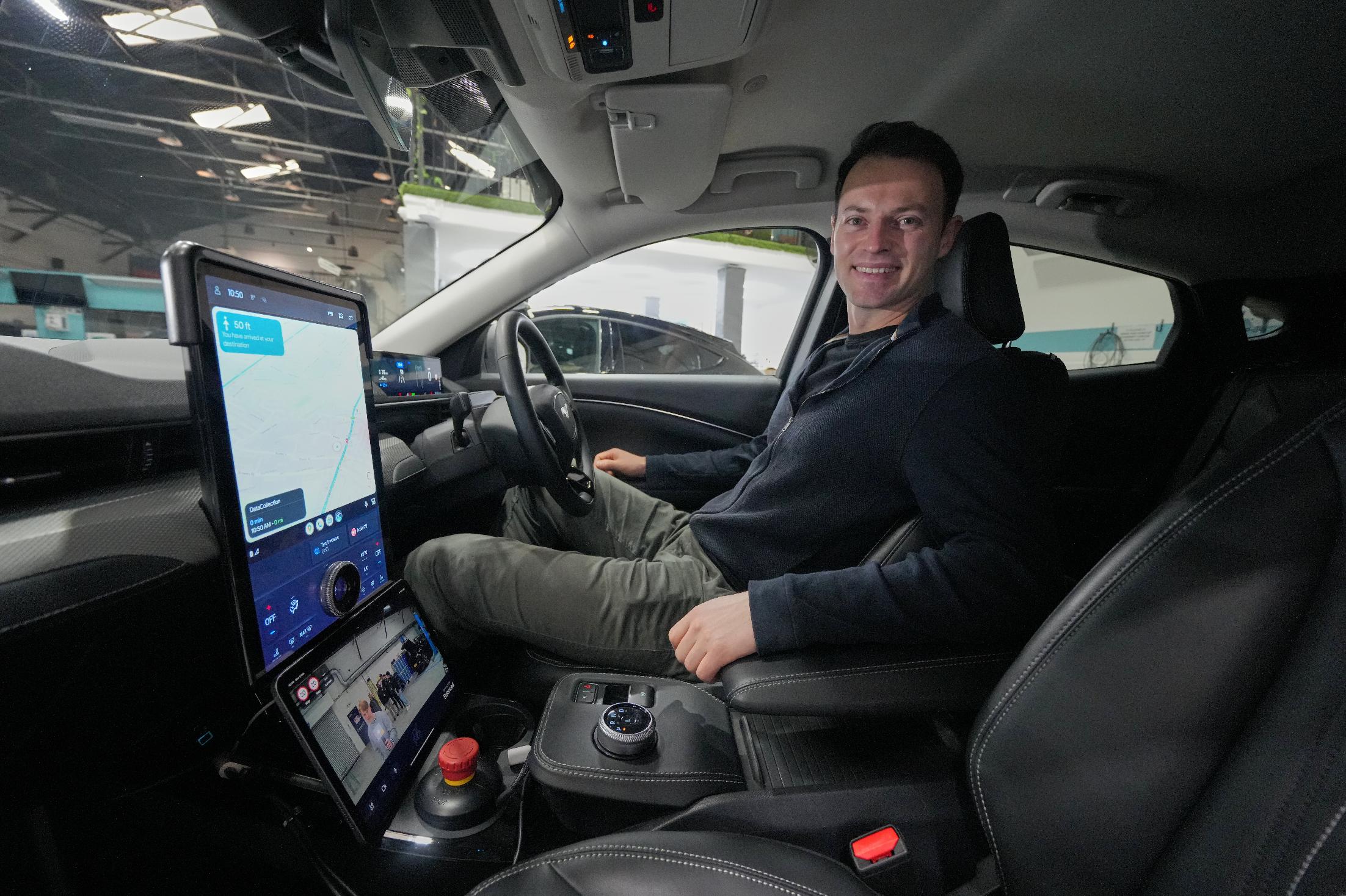 Britain Robotaxis Alex Kendall, co-founder and CEO of Wayve, sits in the autonomous vehicle during an interview in London, Monday, Feb. 9, 2026. (AP Photo/Kin Cheung)