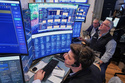 A trio of traders work on the floor of the New York Stock Exchange, Wednesday, June 3, 2026. (AP Photo/Richard Drew)