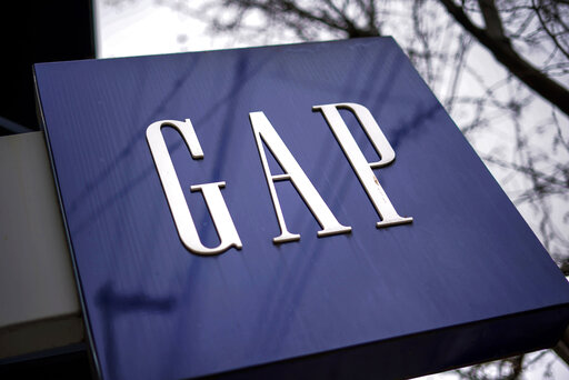 FILE - A sign for the GAP is seen on a storefront in Pittsburgh on Wednesday, Jan. 12, 2022. Gap is slashing 500 corporate jobs in San Francisco and New York as it looks to reduce expenses amid languishing sales, a company spokesperson confirmed on Tuesday, Sept. 20, 2022. (AP Photo/Gene J. Puskar, File)