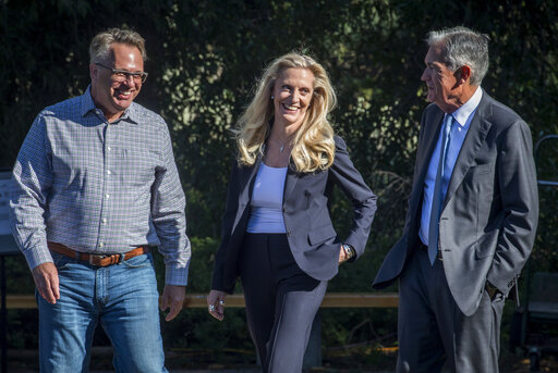 Federal Reserve Chair Jerome Powell, right, takes a break with Federal Reserve Vice Chair Lael Brainard, center, and Federal Reserve Bank of New York president and CEO John Williams, left, at the central bank's annual symposium in Grand Teton National Park Friday, Aug. 26, 2022. in Moran, Wyo. (AP Photo/Amber Baesler)