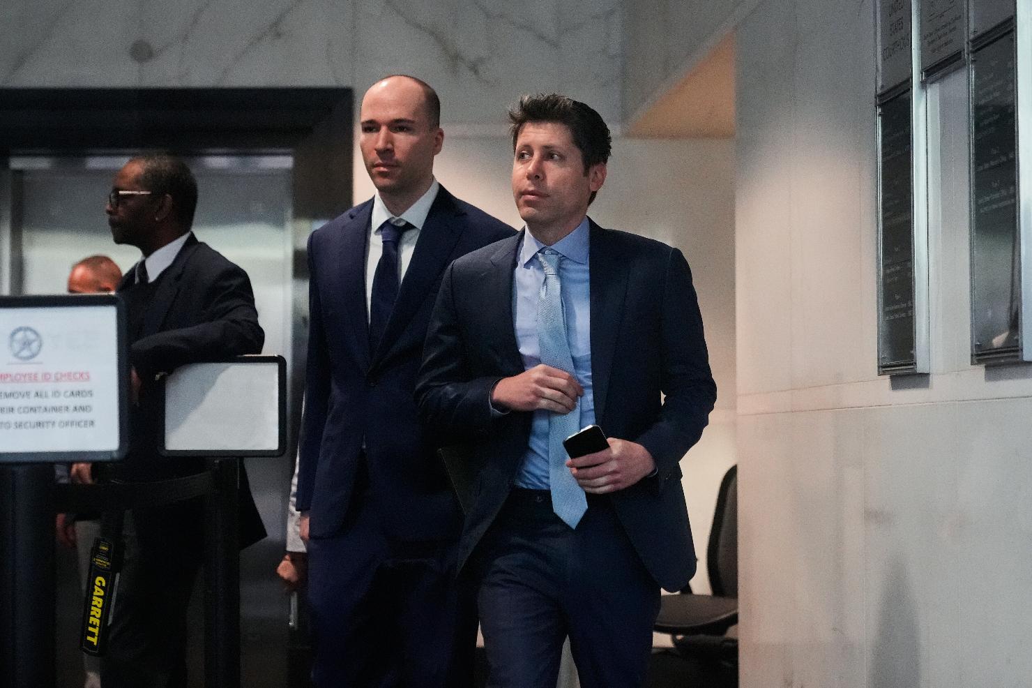Sam Altman, right, and OpenAI president Greg Brockman, center, arrive at the U.S. District Court in Oakland, Calif., Thursday, April 30, 2026. (AP Photo/Godofredo A. Vásquez)