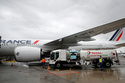FILE - Workers refuel an Airbus A350 with sustainable aviation fuel at Roissy airport, north of Paris, Tuesday, May 18, 2021. (AP Photo/Christophe Ena, File)