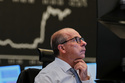 A broker watches his screens at the stock market in Frankfurt, Germany, Friday, April 17, 2026. (AP Photo/Michael Probst)