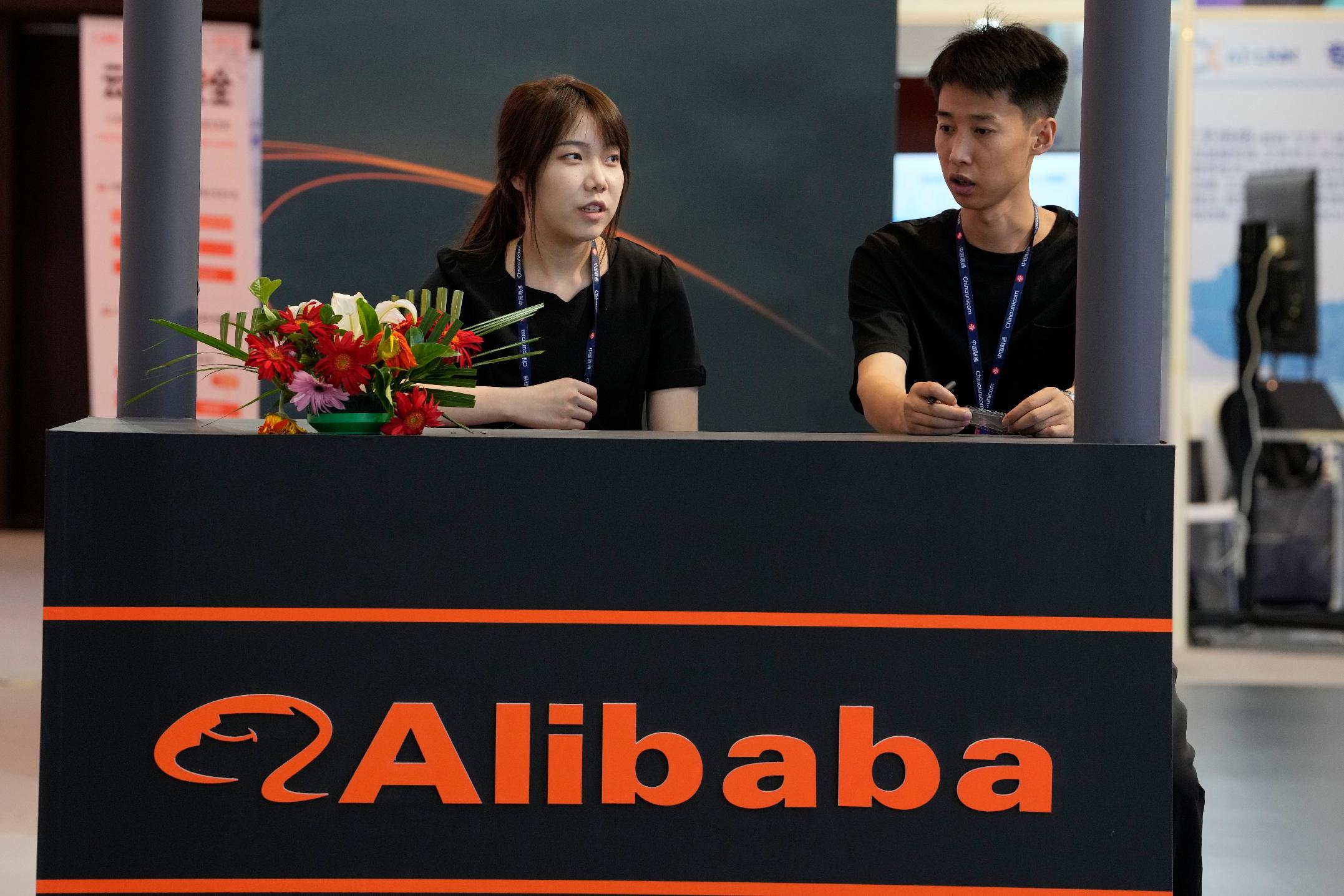 Workers wait for visitors to the Alibaba booth at an expo in Beijing on June 5, 2023. Alibaba Group on Tuesday, June 20, 2023 announced that Eddie Wu, chairman of its e-commerce group, would succeed Daniel Zhang as CEO in a major management reshuffle, as Alibaba undertakes a restructuring of its businesses in hopes of spurring growth. (AP Photo/Ng Han Guan)