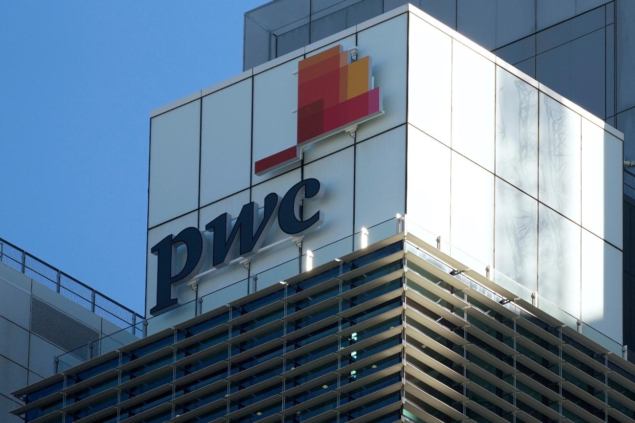 FILE - Signage appears on the Australian head office building of PricewaterhouseCoopers in Sydney, Monday, June 26, 2023. (AP Photo/Rick Rycroft, File)