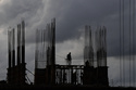 Workers at a construction site are silhouetted against the evening sky filled with pre-monsoon rain clouds in Kochi, southern Kerala state, India, Tuesday, June 2, 2026. (AP Photo/ R S Iyer)